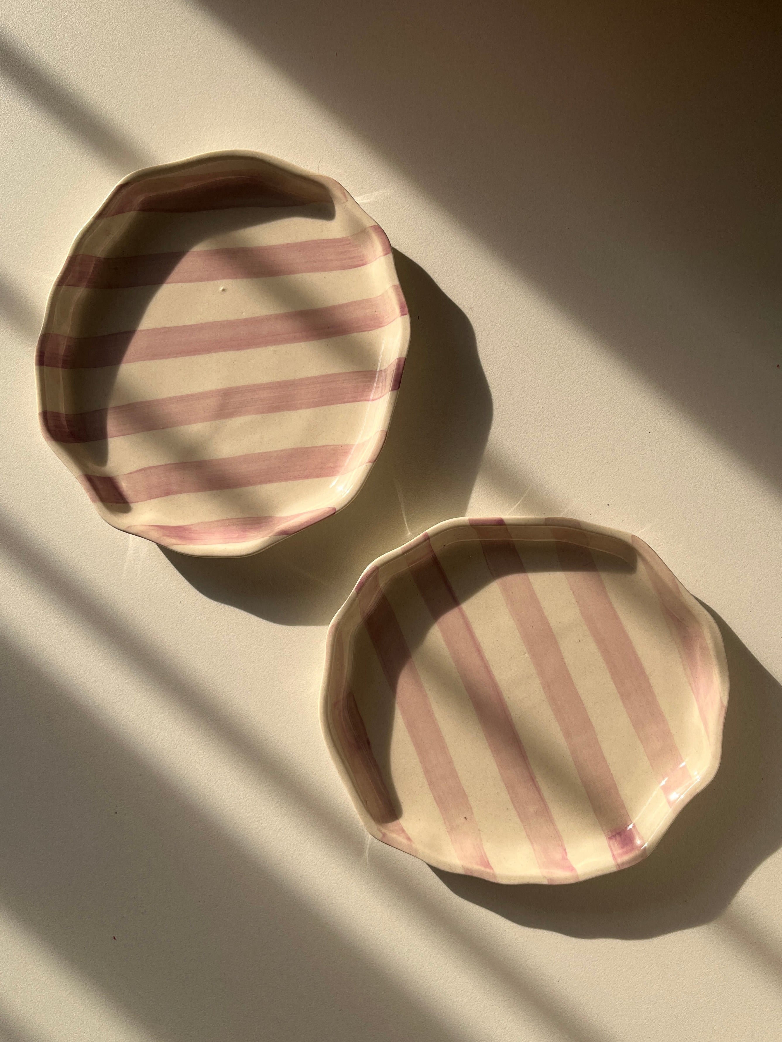 Pair of purple and white striped ceramic plates