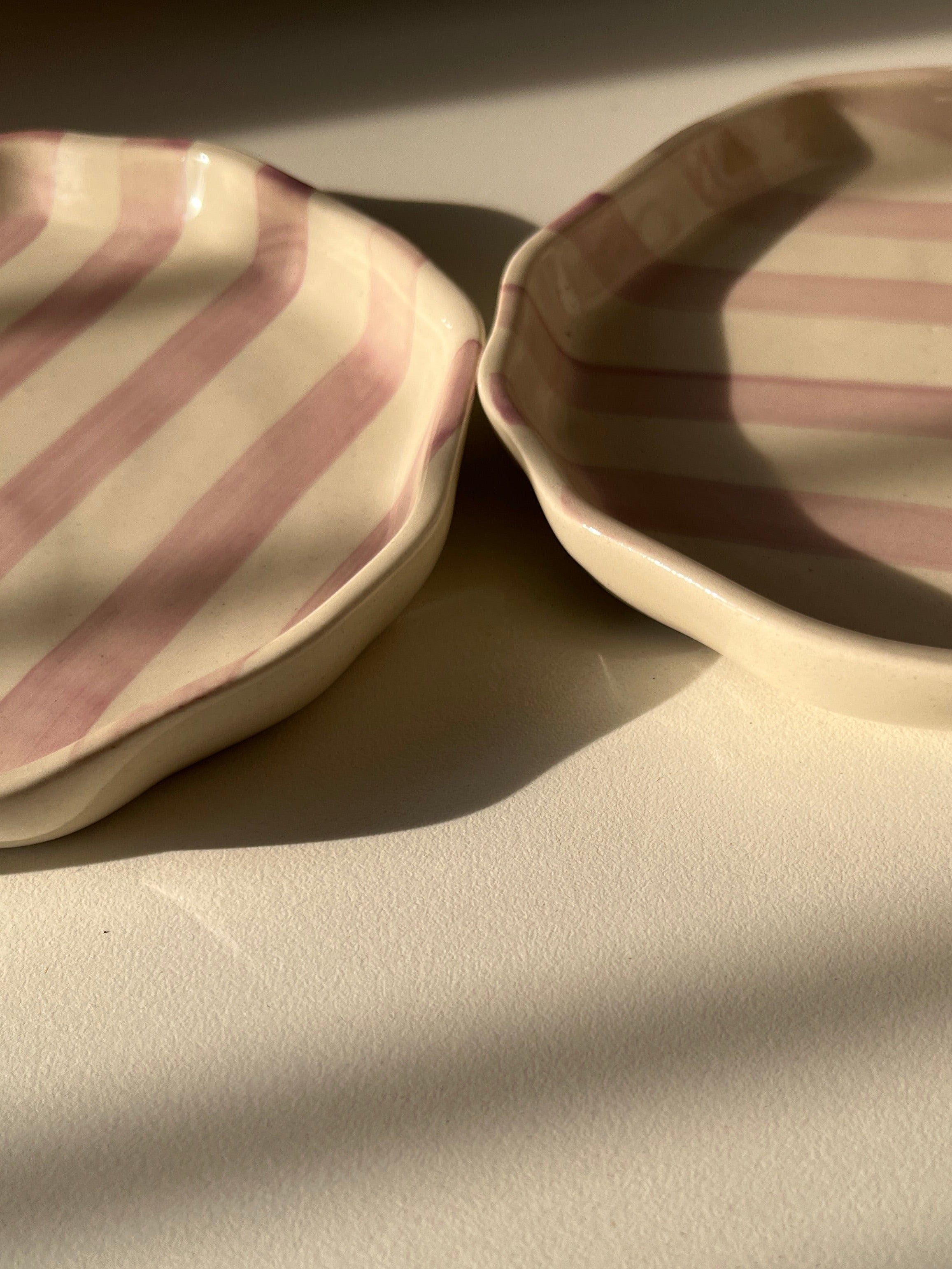 Close-up of a quarter ceramic plate with purple striped pattern