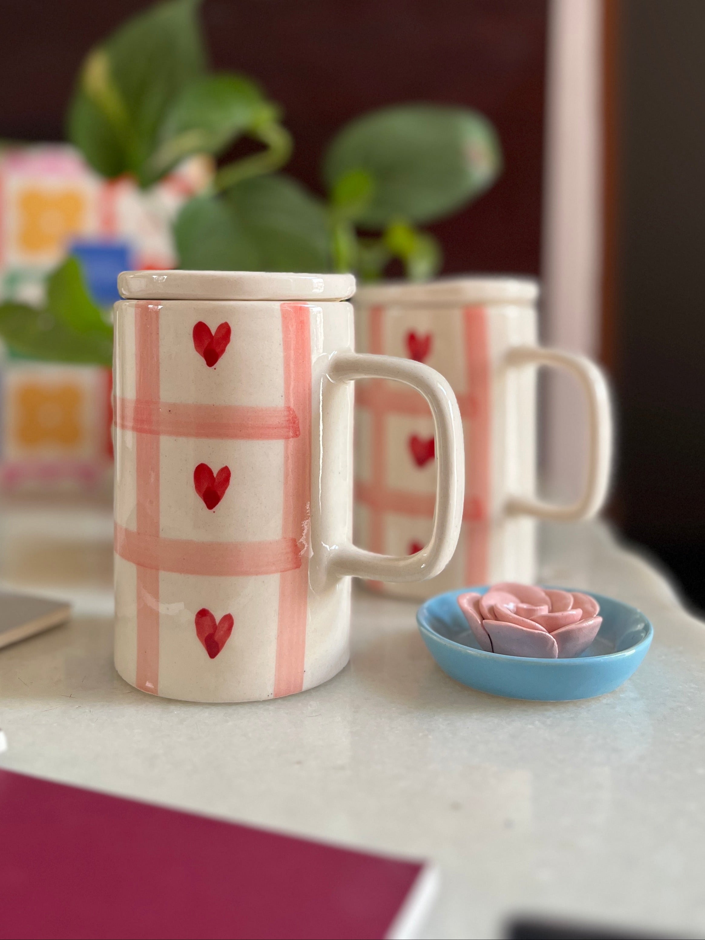 Pink checks with red heart ad a lid. Tall mug and slim. 