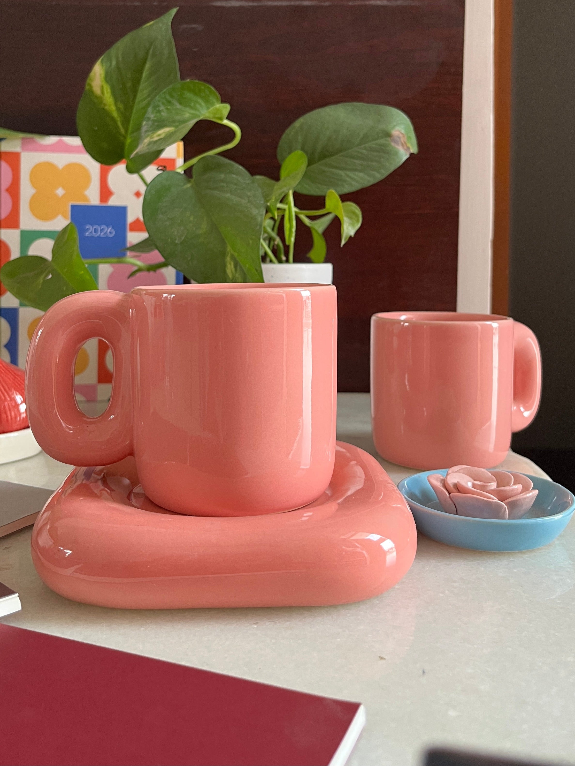 Glossy solid pink coffee mug with saucer