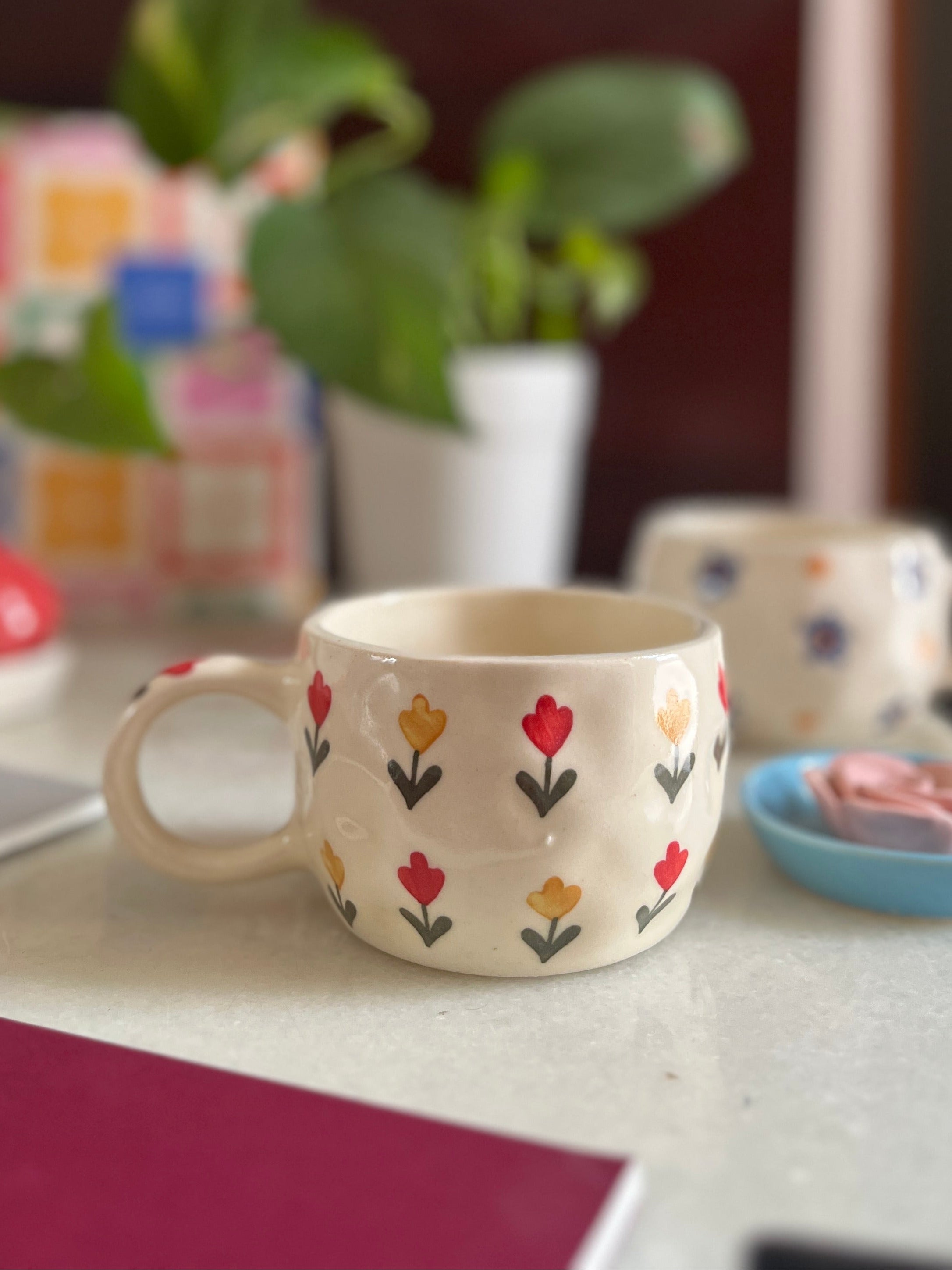 red and yellow flowers on a ceramic cup