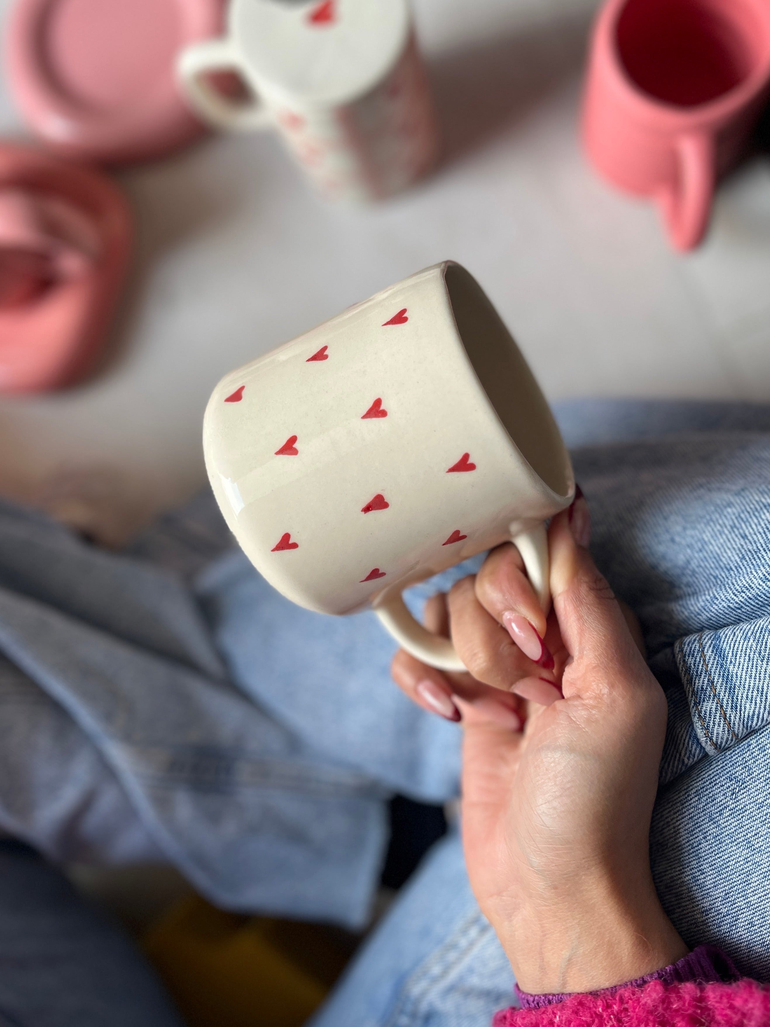Ceramic mug with small red hearts, coffee, tea, drinking