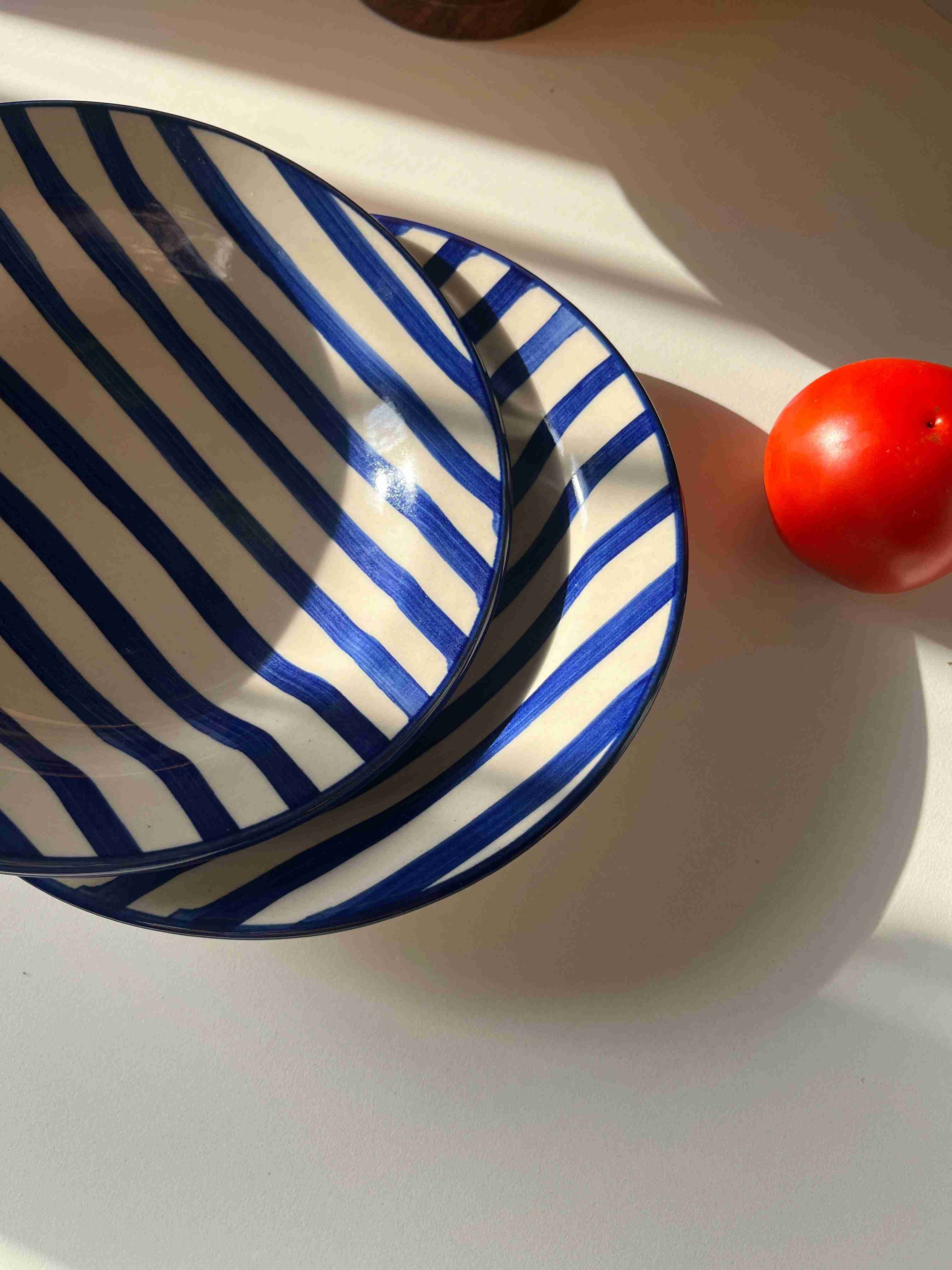 Glossy ceramic pasta plate with coastal-inspired blue stripes