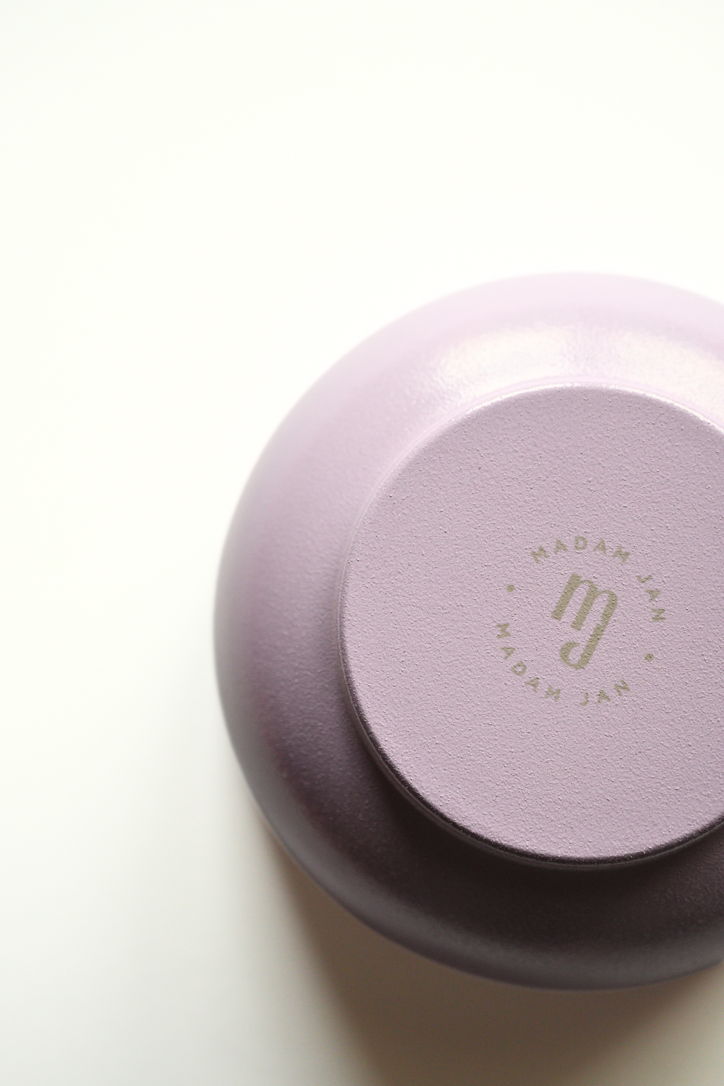 Lavender metal bowl with 'MADAM JAN' branding on a white background