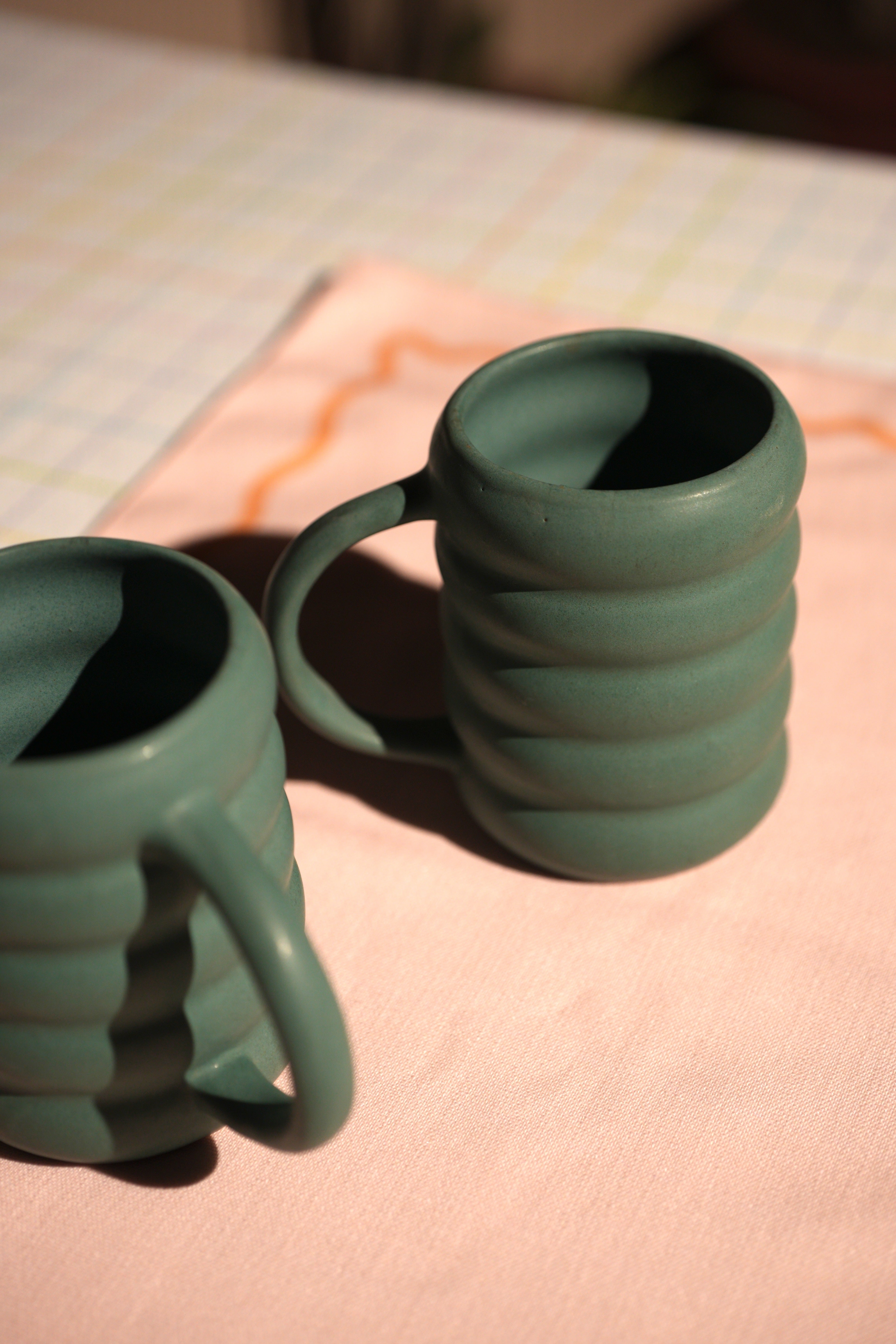 Buttercup Mug in soothing green ceramic with matte glaze and fluted texture