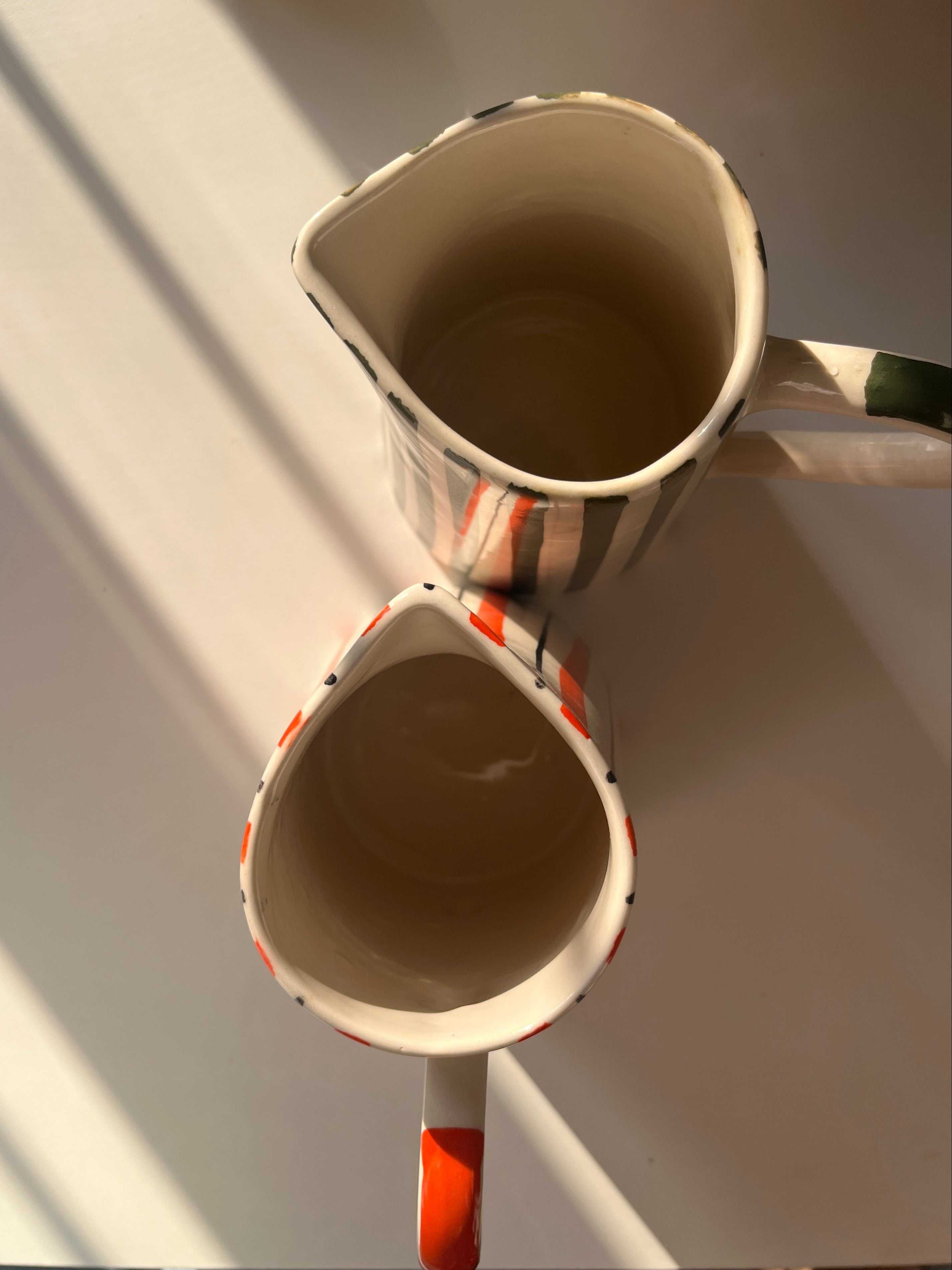 Top view of tall ceramic jug vase with hand-painted striped design
