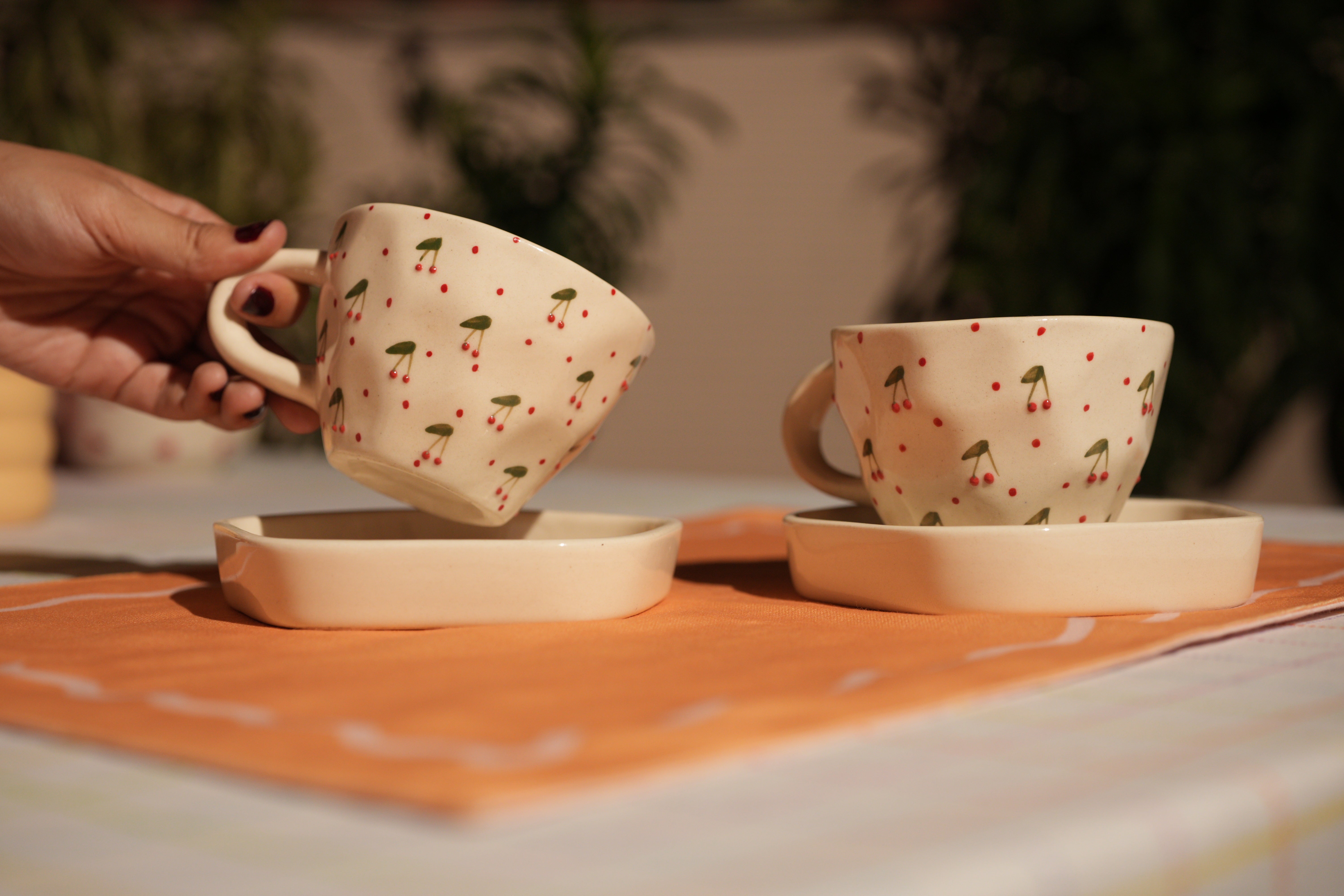 a pair of Cute ceramic mug with raised cherry accents