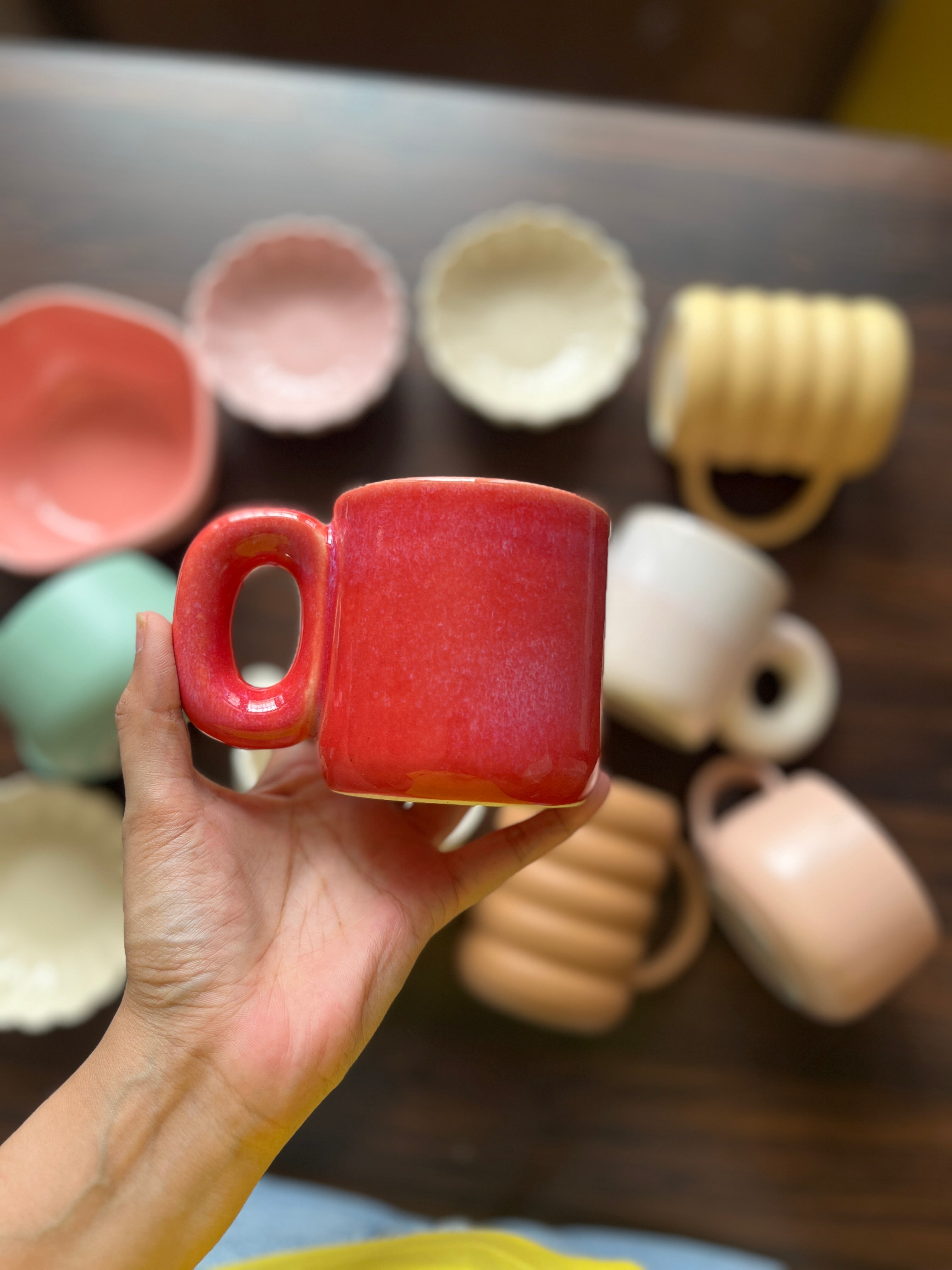 Red gradient ceramic mug with contemporary design held in hand perfect for coffee