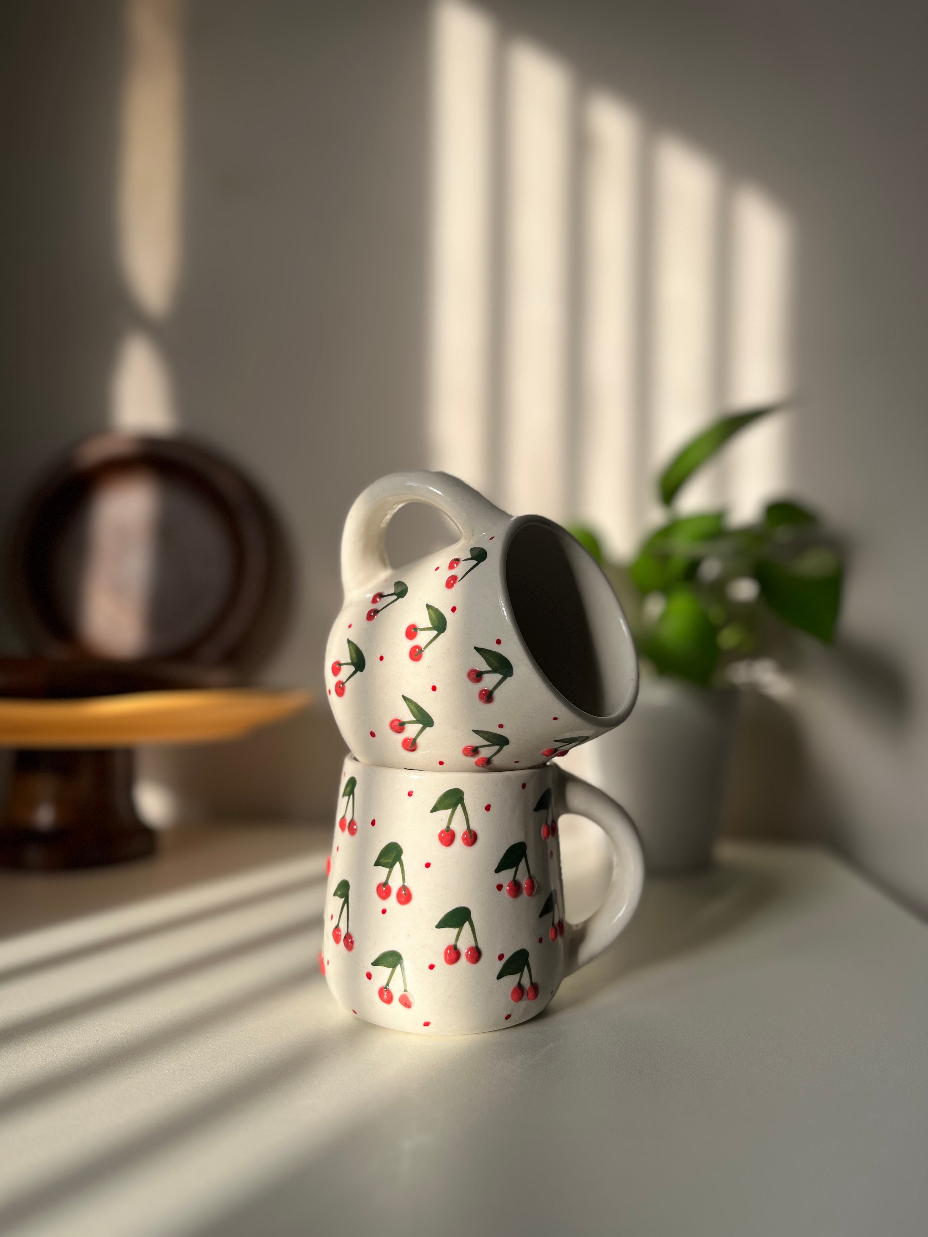 Ceramic coffee mug with playful 3D cherry detailing