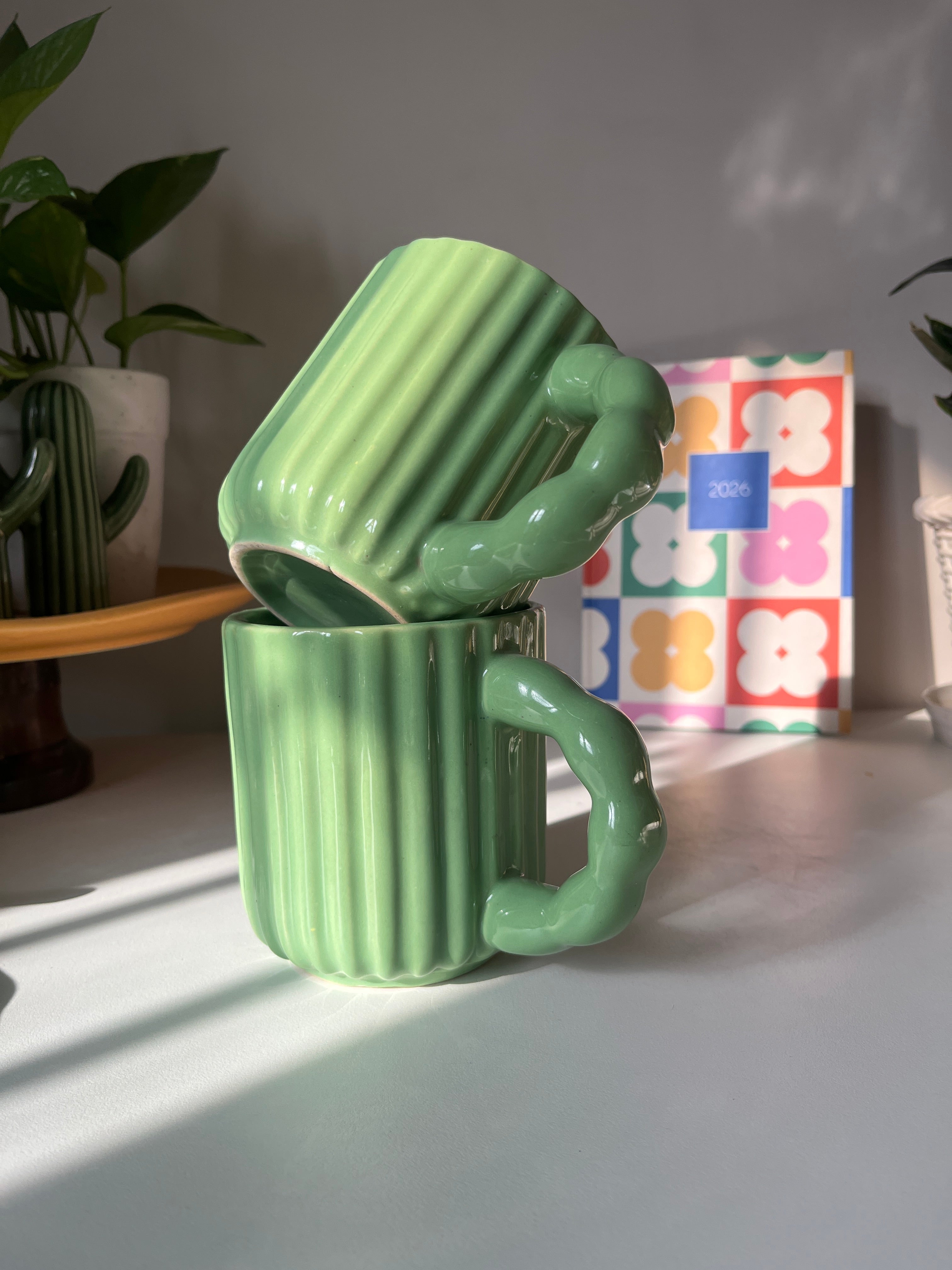 Kiwi Mug in glossy green ceramic with ribbed texture and sculptural handle by Madam Jan
