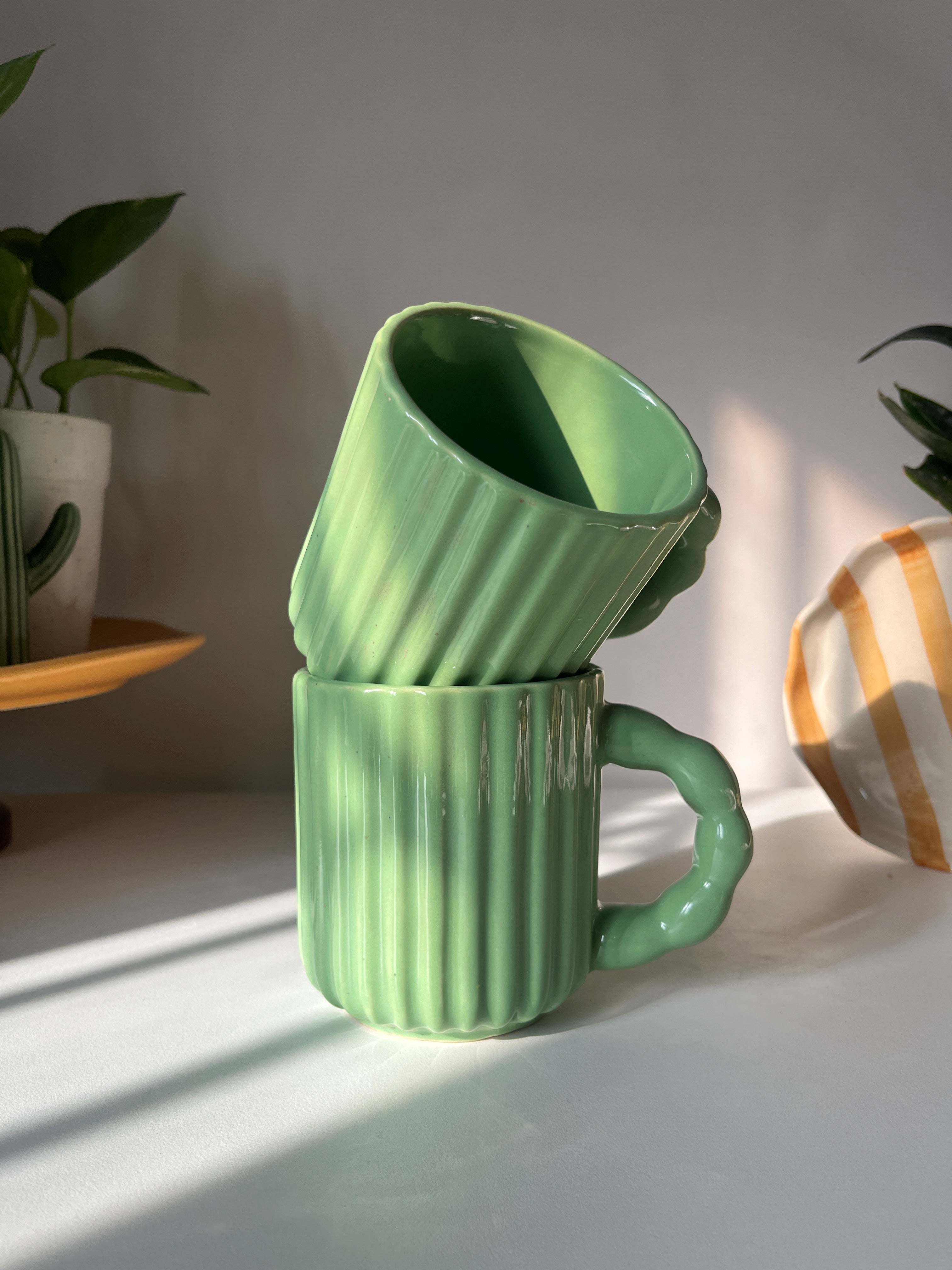 Kiwi Mug featuring a glossy green glaze and textured ceramic body