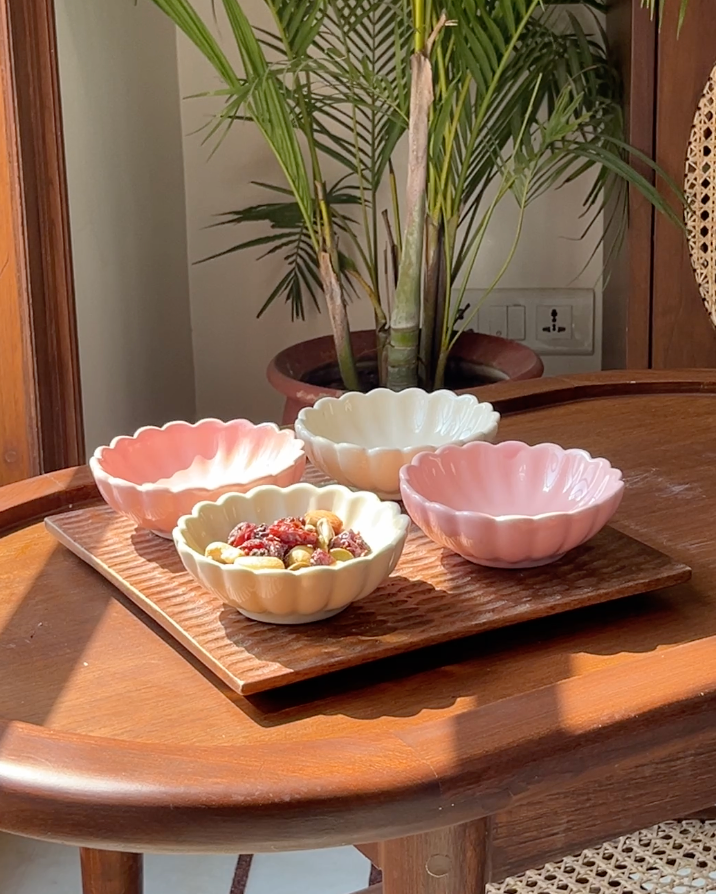 Loom & Bloom serving set featuring a scalloped wooden tray and four ceramic flower bowls.