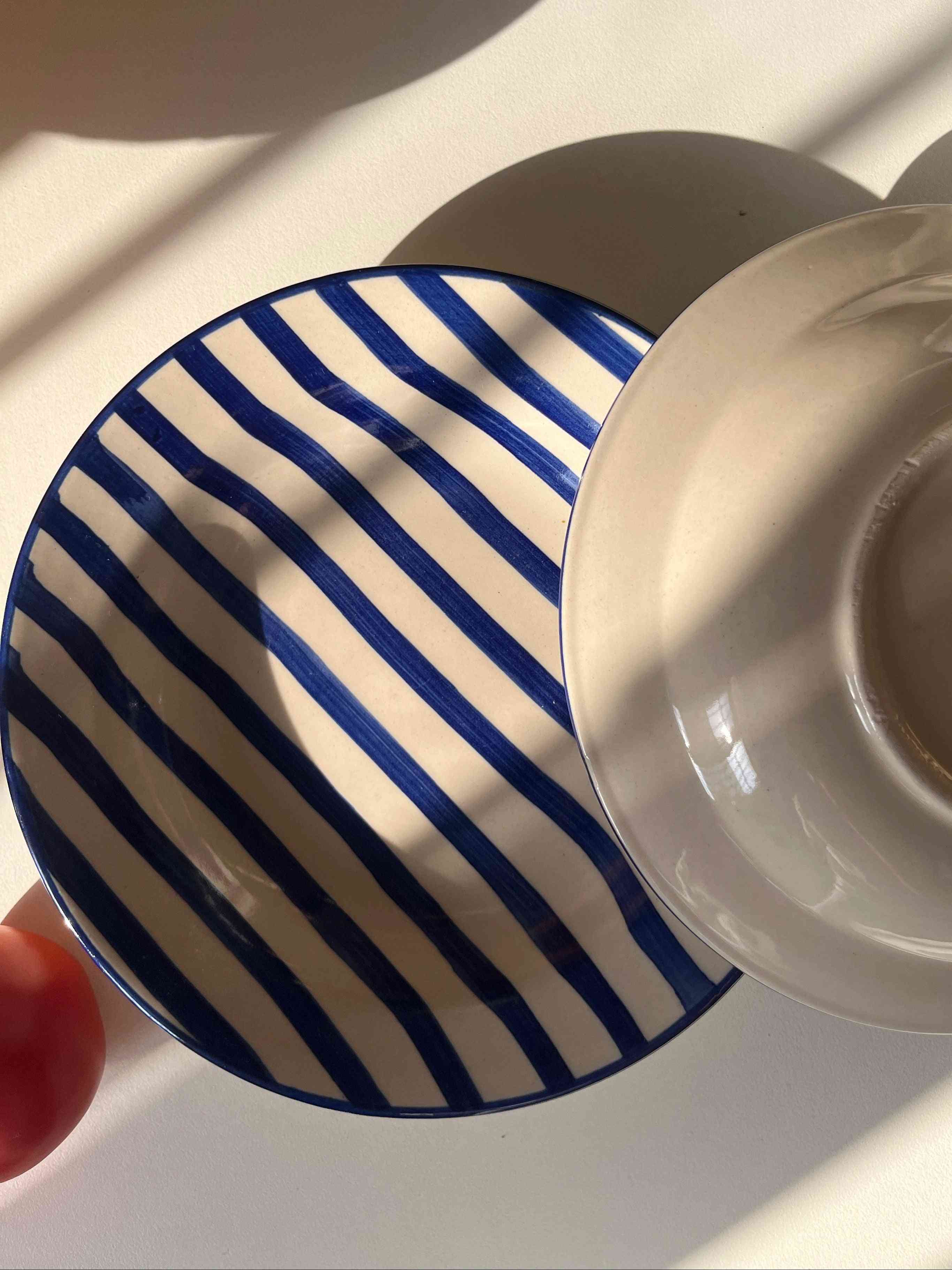 Ceramic serving plate with hand-painted blue striped design