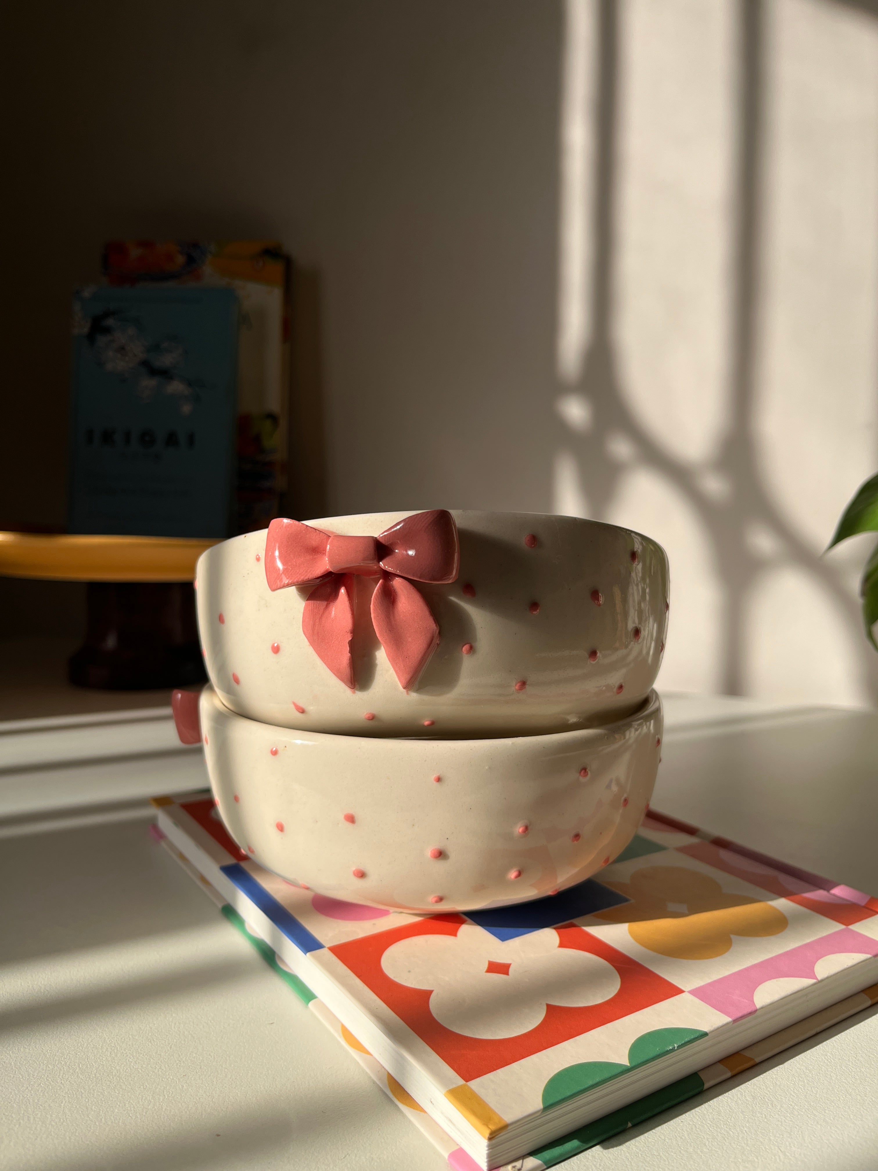 Glossy pink ceramic serving bowl with raised details