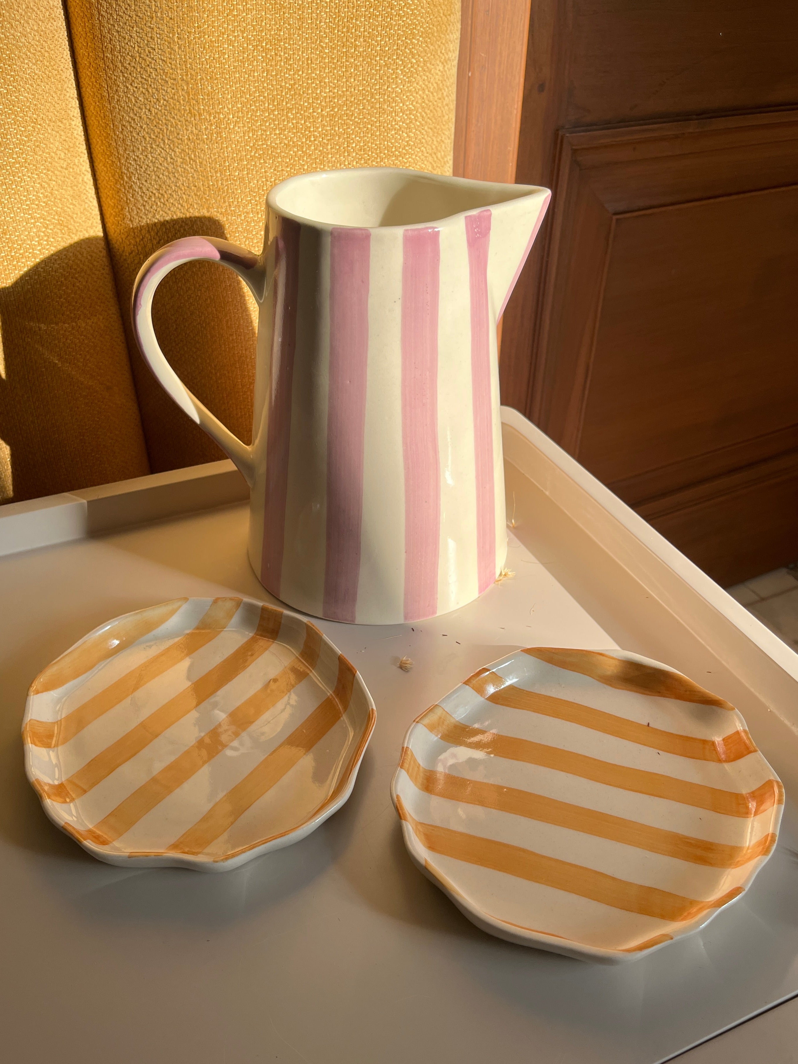 Ceramic jug vase and plate set designed for serving and home styling.