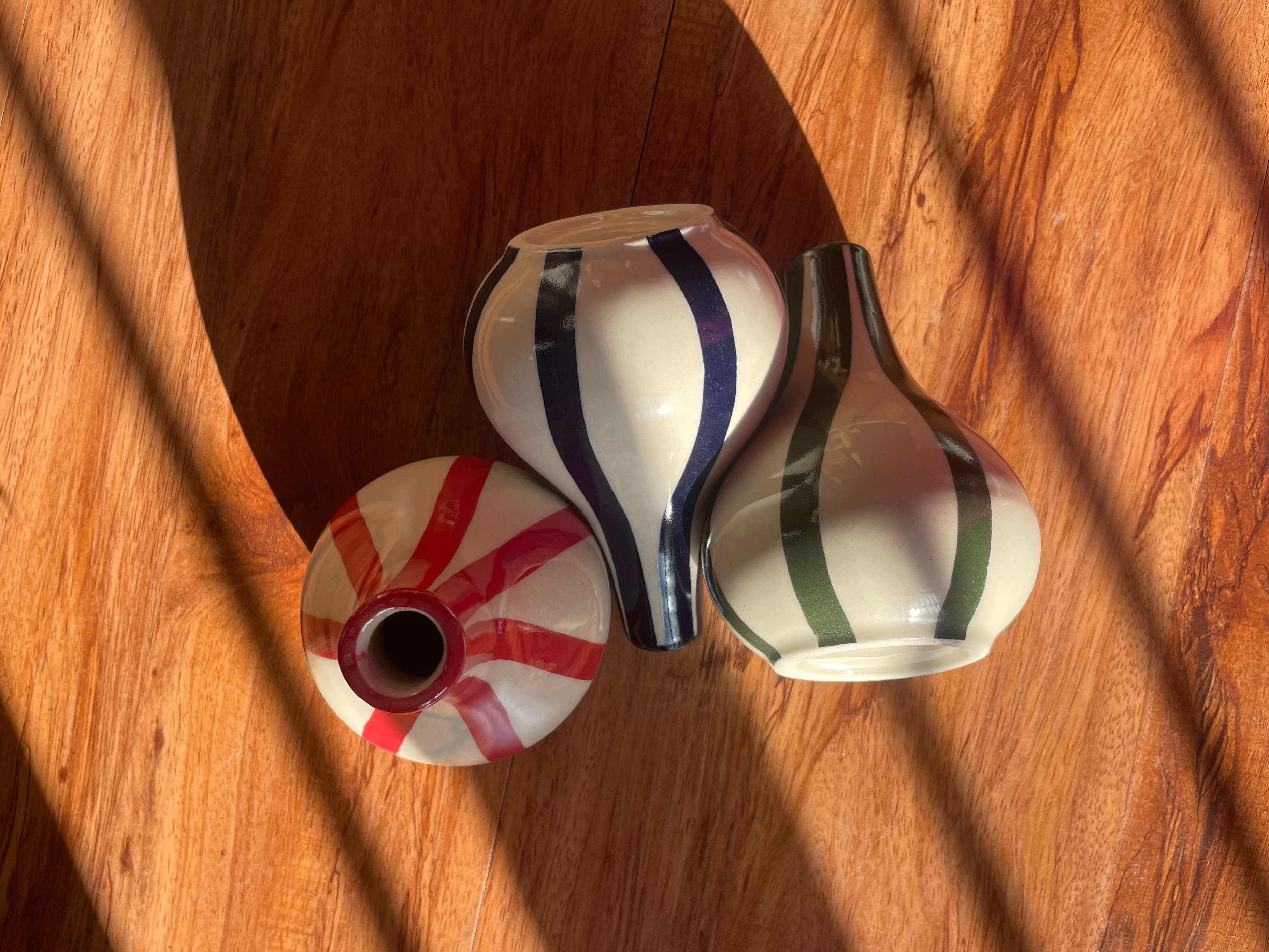 Top and front view of the Stems & Stripes vase trio with three petite striped vases.