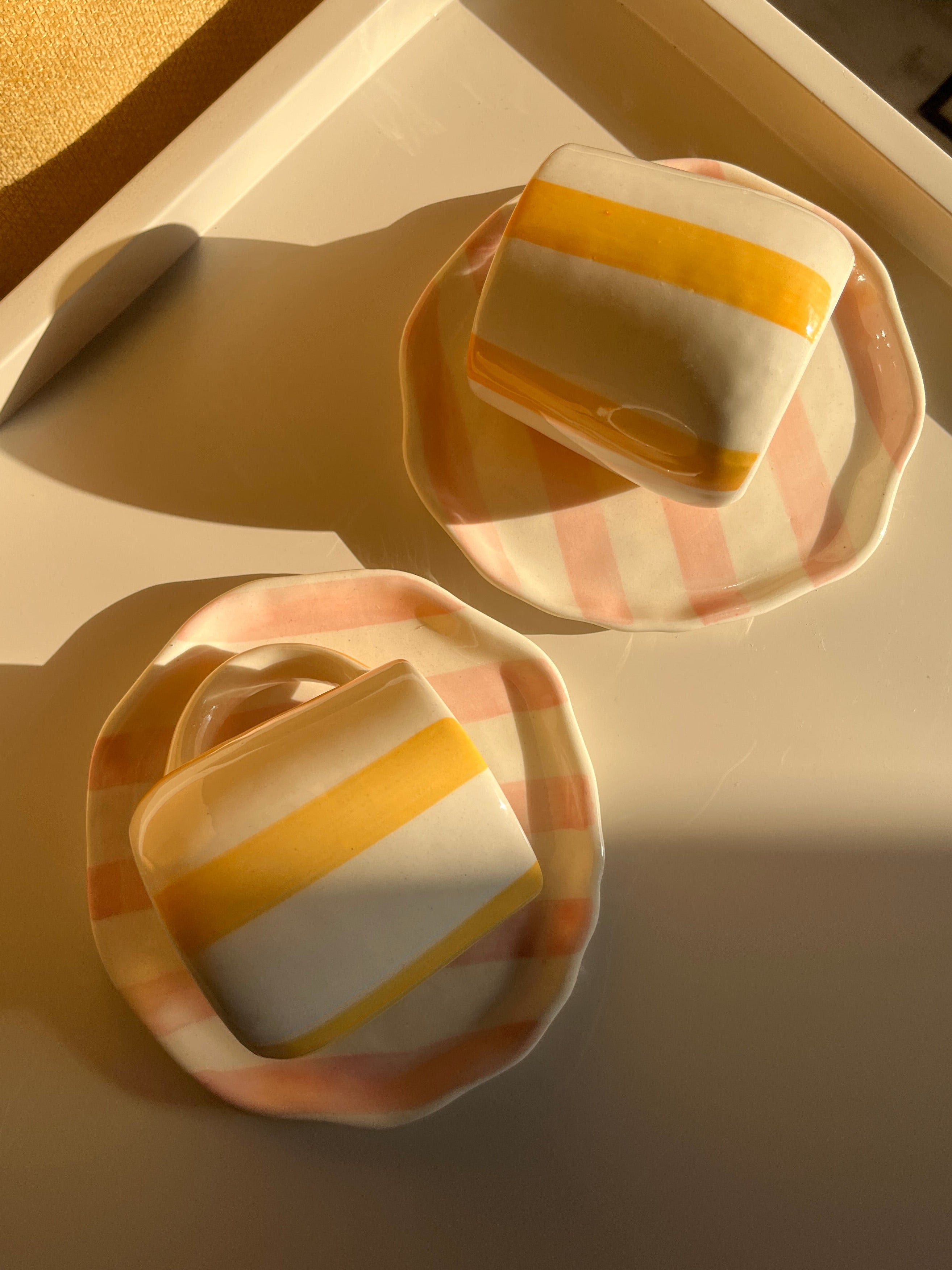 Top view of the Taffy Time set with two ceramic mugs and two matching plates.
